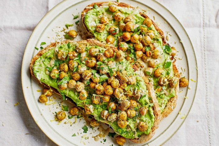 Two slices of chickpeas on toast on a white plate
