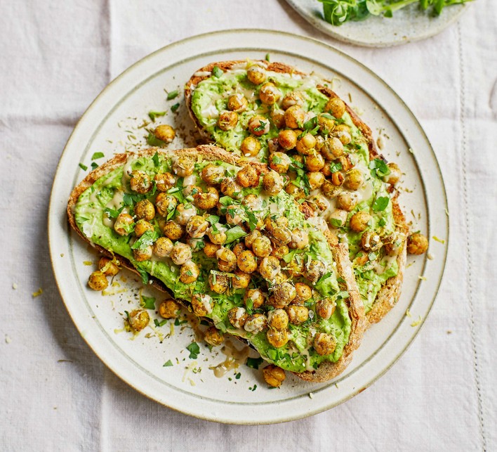 Two slices of chickpeas on toast on a white plate
