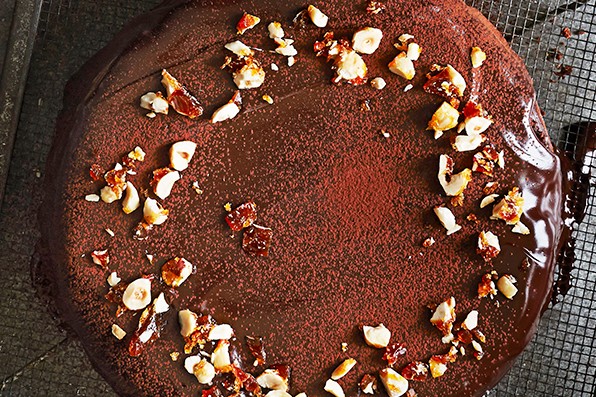 Chocolate cake topped with chopped hazelnuts