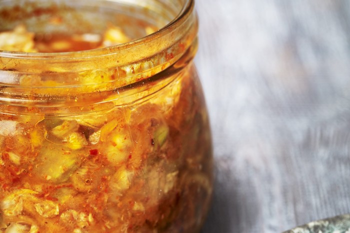 A glass jar filled with pickled vegetables