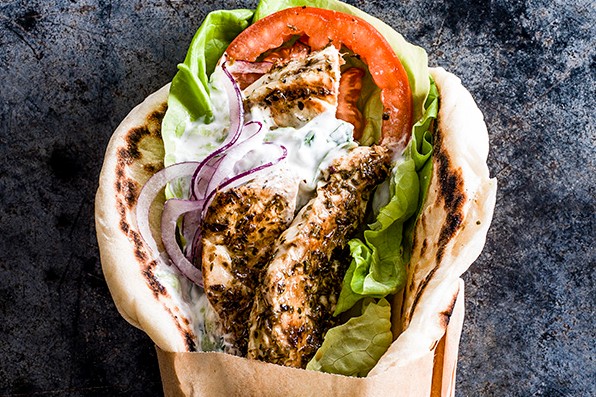 Chicken gyros in a wrap with lettuce, tomatoes and tzatziki
