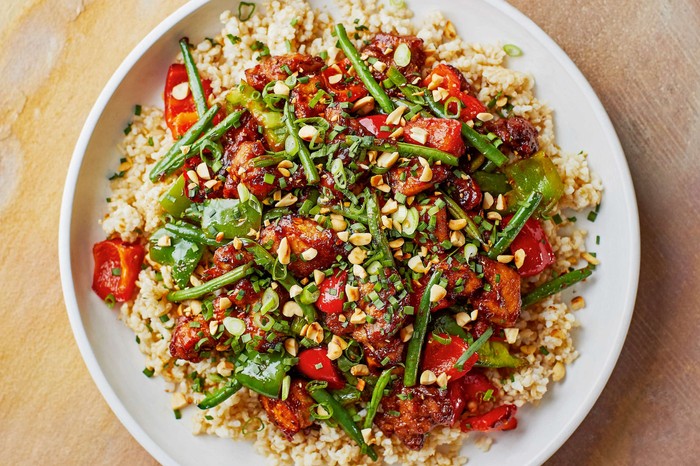 A takeaway-style chicken dish on a white plate