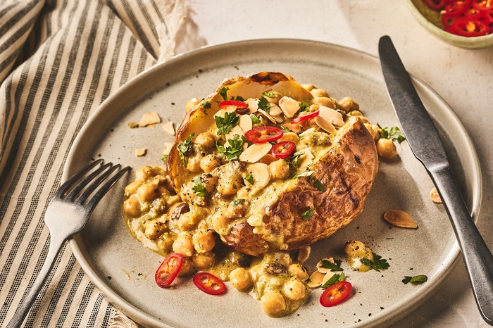 A split jacket potato filled with chickpeas