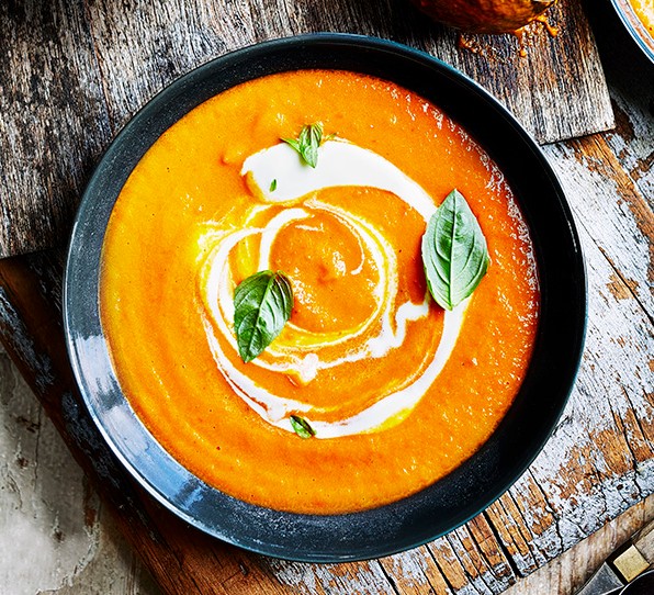 A bowl of tomato soup, with a swirl of creme fraiche