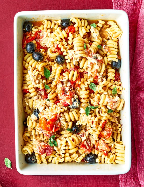 Baked feta pasta with tomatoes and olives, in a baking dish