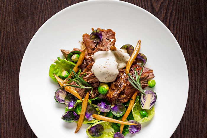 Slow-roasted leg of lamb with roasted salsify brussel tops & bang cauda at Bernardi's, London