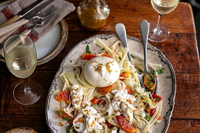 A sharing platter of blood orange, burrata and fennel salad with a whole burrata in the middle