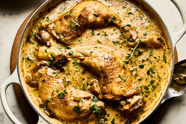 Pot of chicken fricassee topped with herbs