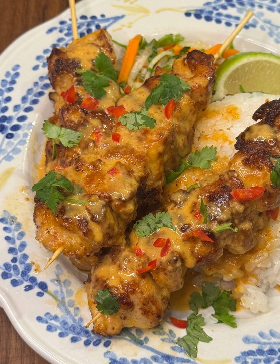 Chicken satay skewers on rice