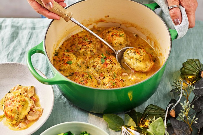 Chicken casserole in a green dish with a serving plate