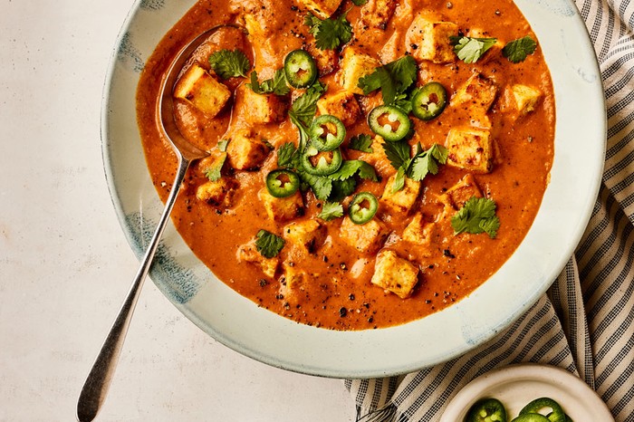 Bowl of tofu curry topped with chilli and coriander