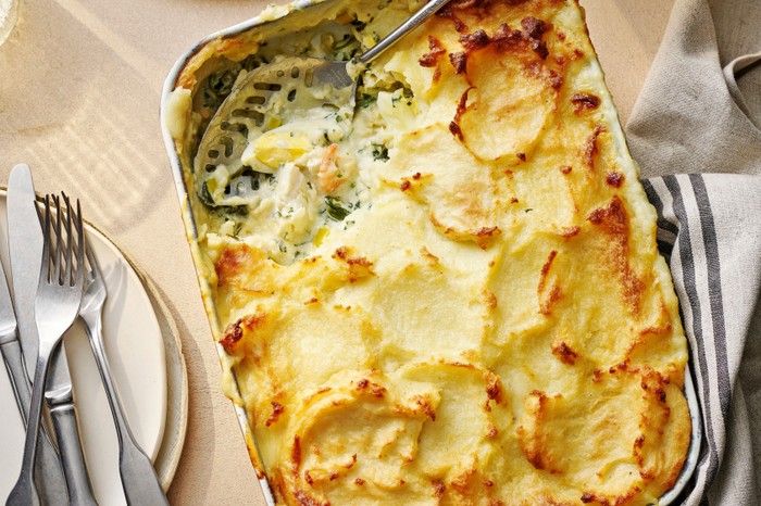 Baking dish of fish pie with a serving removed