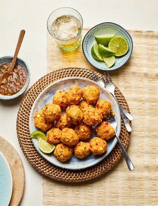 A plate of chilli cakes with dipping sauce on the side
