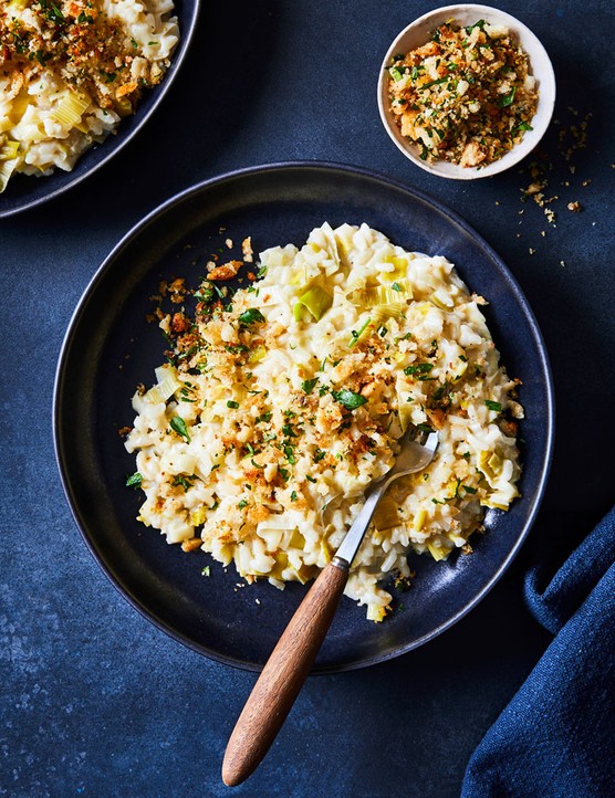 Leek risotto in a bowl topped with fried anchovy and breadcrumbs