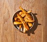 A bowl of roast parsnips drizzled with honey