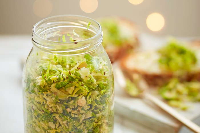 A glass jar filled with shredded sprouts