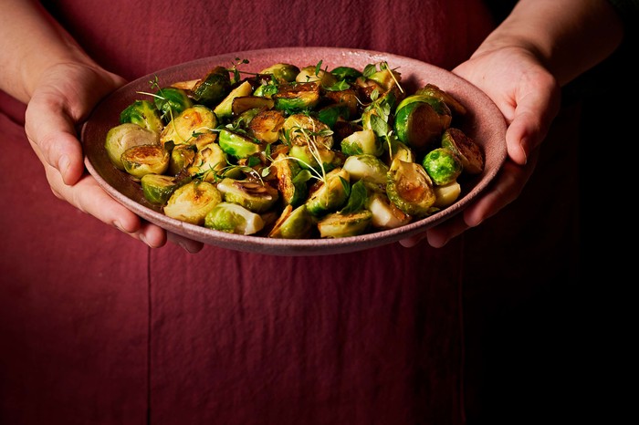 A dish of sprouts in somebody's hands