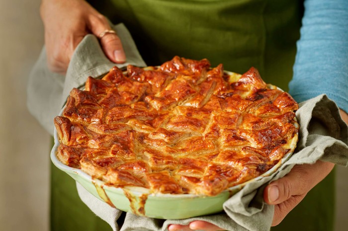 Someone bringing a whole patchwork pie to the table