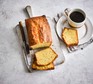 A sliced pound cake with coffee on the side