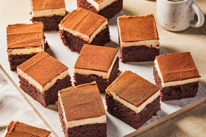 Tiramisu brownies with a cup of coffee in the background