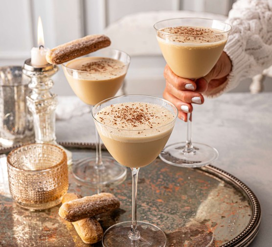 Three tiramisu martinis on a golden serving tray