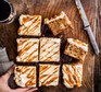 Toffee apple cake with cream cheese icing sliced into 8 separate squares