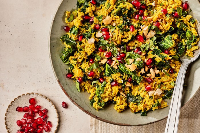 Large bowl of rice topped with coriander and pomegranate seeds