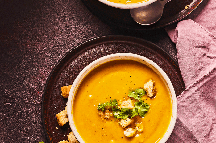 Two bowls of squash and sweet potato soup