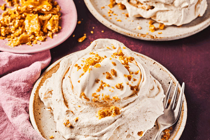 Two meringues with crunchy hazelnut brittle and chantilly cream on top