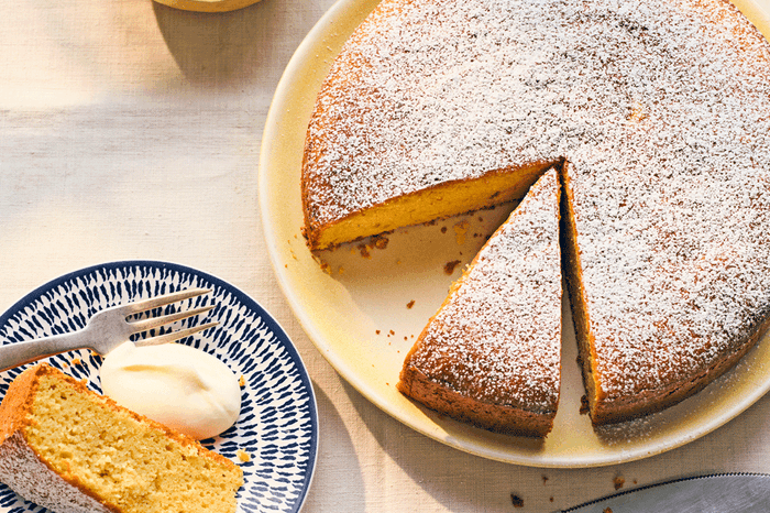 Lemon and olive oil cake with a slice taken out on the side