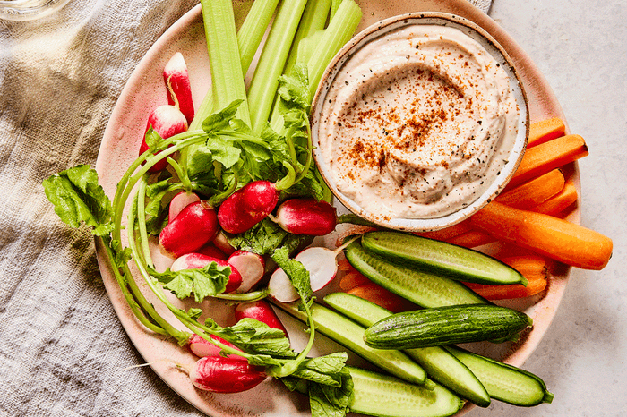 Taramasalata on a plate with chopped vegetable crudités