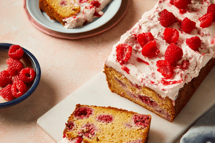 Vanilla raspberry mascarpone loaf cake topped with raspberries